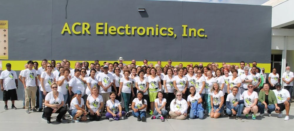 The ACR Electronics team outside the company's Fort Lauderdale headquarters and manufacturing facility