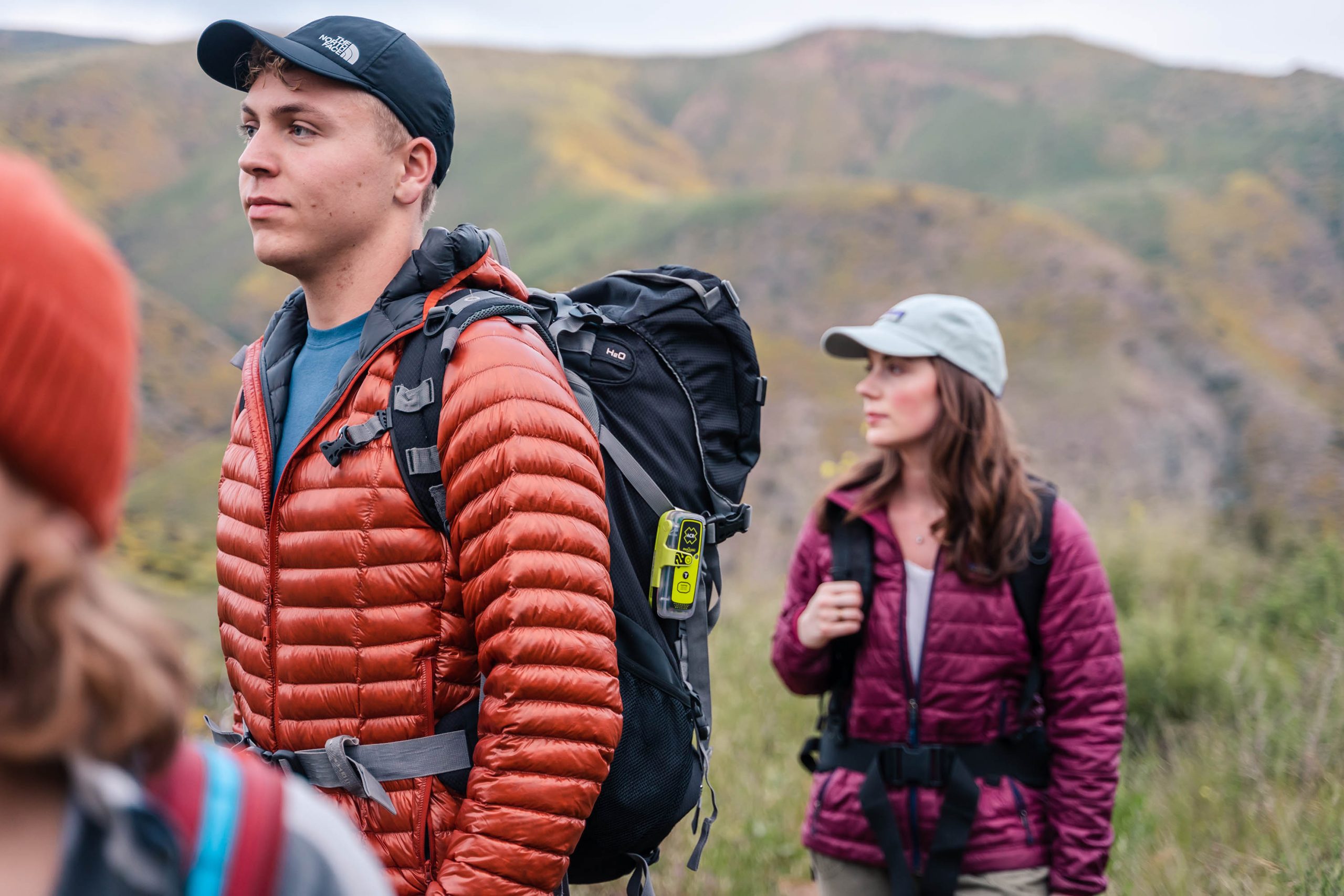 Outdoor adventurer carrying an ACR ResQLink 400 personal locator beacon on a remote trail