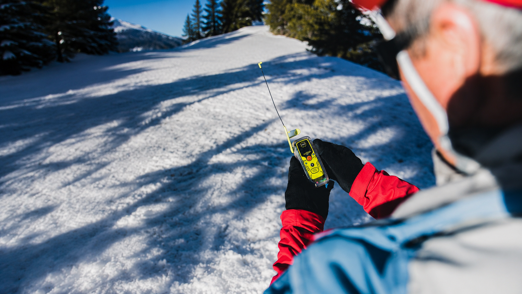 Adventurer activating an ACR ResQLink 400 Personal Locator Beacon with the antenna fully deployed