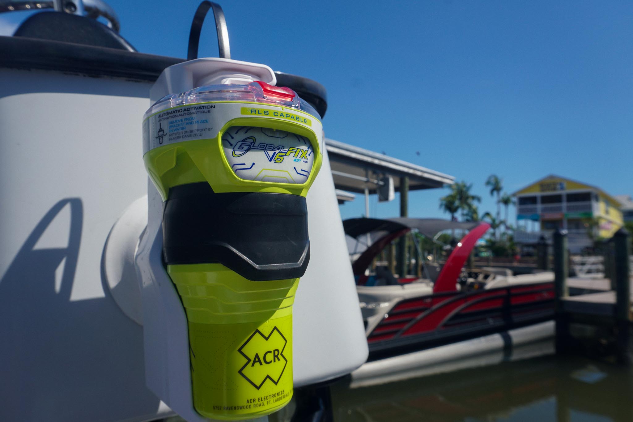 GlobalFix V6 EPIRB in its Category 2 manual-release bracket mounted on a boat