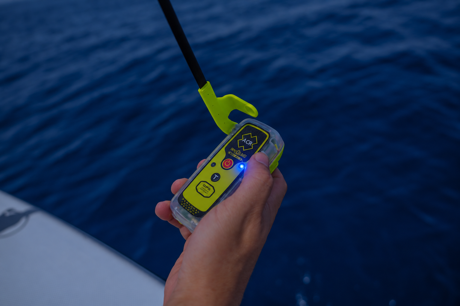 ACR ResQLink 410 RLS personal locator beacon with its blue Return Link Service LED illuminated